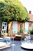 Set table in summery garden of old brick house