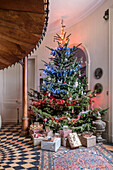 Ten foot Christmas tree decorated with red, white and blue lights welcomes guests as they enter the hall.