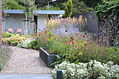 Flowerbeds with and without edging and a paved path in a garden