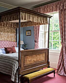 Antique four-poster bed in the classic English-style bedroom
