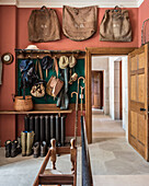 Old bags above the coat rack in the English style entrance hallway