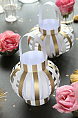 Lanterns handmade from gold and white striped paper