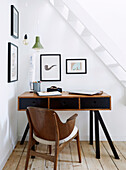 Small workstation under white staircase