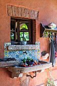 Stone sink and colourful wall tiles on the veranda