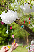 Mobile with colorful paper raindrops hanging from a cloud made of tissue paper