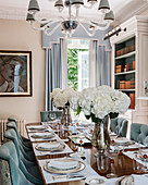 White hydrangeas on set table in elegant dining room