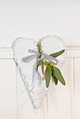 Rose and eucalyptus branch on a white deco heart