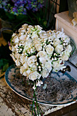 Heart-shaped arrangement of white roses and bouvardia