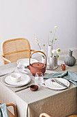 Set table with linen tablecloth and classic chairs