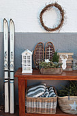 Wintry arrangement of skis and console table against outside wall