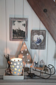 Wintry arrangement of candle lanterns, sledge and gnomes in shades of grey