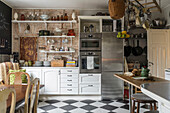 Spacious kitchen with chequered floor tiles