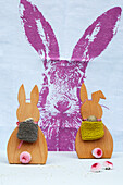 DIY wooden bunnies with knitted backpacks and bellis tails