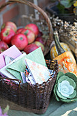 Basket with DIY folded seed bags, a basket with apples, felt succulent