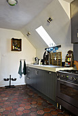 Honeycomb floor tiles in country-house kitchen below sloping ceiling