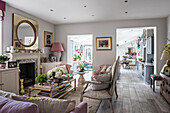 Knocked through and enlarged living space with vintage coffee table and French-style sofa