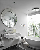 White, modern, designer bathroom with glass wall