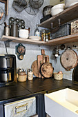 Old kitchen utensils on shelves of vintage-style kitchen