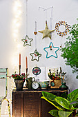 Antique trunk used as table below various handmade star decorations on wall