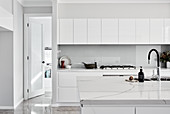 White, modern, minimalist, kitchen with high-gloss cabinets