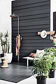 Outdoor shower on terrace with dark wooden planks