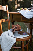 Bundt cake on chair next to table in garden