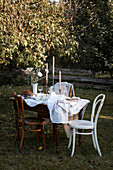 Festively set table in the late summer garden