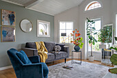 Velvet upholstered furniture in modern living room with indoor plants
