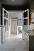 Double door in luxurious bathroom in grey and white with marble tiles