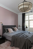 Glamorous bedroom in pink and grey in an old building