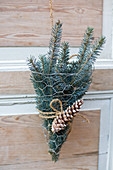 Small spruce bouquet with cones as a door decoration