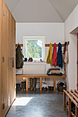 View into utility room with coat racks