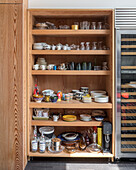 Open shelving in kitchen full of crockery and glassware