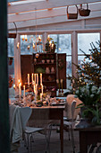 A view of Christmas table with burning candles