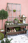 Rustic console with flower pots and nest boxes on the terrace