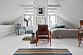 Attic bedroom with white floorboards