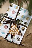 Wrapped Christmas present with gingerbread tag