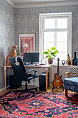 Study corner in the room with patterned wallpaper