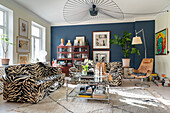 Sofa set with an Animal print and glass coffee table in the living room with blue wall