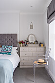 Acrylic chair and bureau in the bedroom in grey