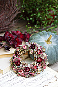 Wreath of hydrangea flowers and everlasting flowers on a pumpkin