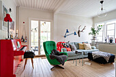 Red piano and green armchair in eclectic living room