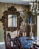 Opulent baroque mirror on tiled wall in dining room