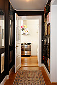 View into kitchen from hallway with black walls