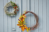 Wreaths of Santolina, cotoneaster and knotweed in autumn colours on door