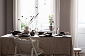 Table set with linen tablecloth and black crockery