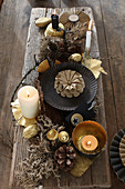 DIY Advent arrangement with Christmas decorations and dried plants on long wooden board