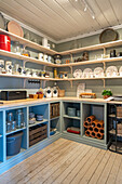 Spacious pantry with shelves and wooden floorboards