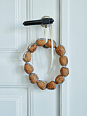 Small wreath of walnuts on door handle