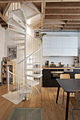 Open-plan kitchen with dining area and spiral staircase